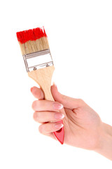 Hand with brush and red paint isolated on white