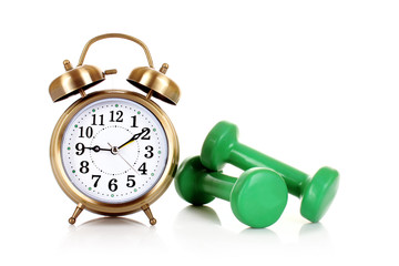 Old alarm-clock and dumbbells isolated on white