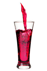 Isolated glass with splashing refreshing a red color drink  on w