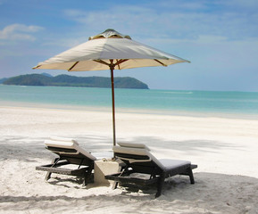 chairs and umbrella on sand beach