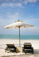 chairs and umbrella on sand beach