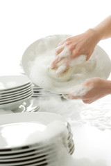 Washing dishes - hands with gloves in kitchen