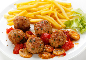 Roasted meatballs, French fries and vegetables