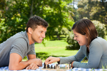 Couple playing chess in the park
