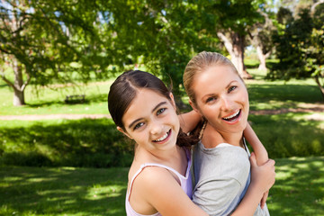 Naklejka premium Daughter playing with her young mother