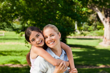 Naklejka premium Mother having daughter a piggyback