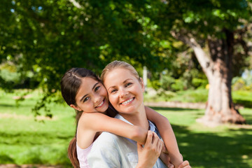 Naklejka premium Mother having daughter a piggyback