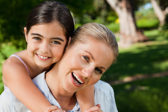 Cute daughter with her mother in the park