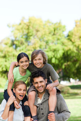 Parents giving children a piggyback