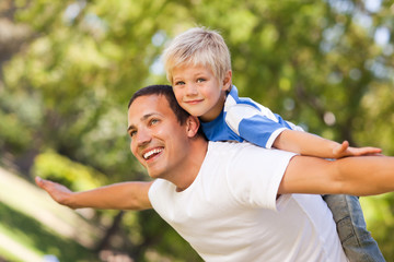 Son playing with his father in the park © WavebreakMediaMicro