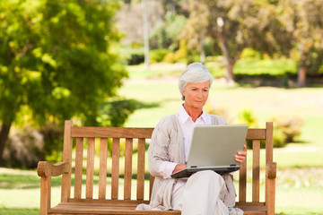 Fototapeta premium Retired woman working on her laptop