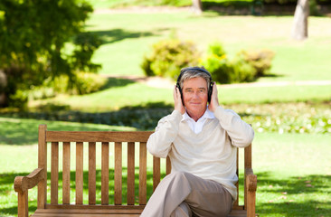 Fototapeta premium Retired man listening to some music