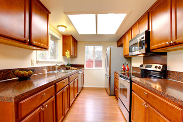 Kitchen warm maple color with stainless steal appliances