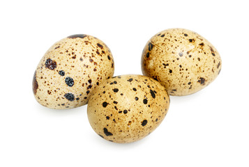Three quail eggs isolated on white