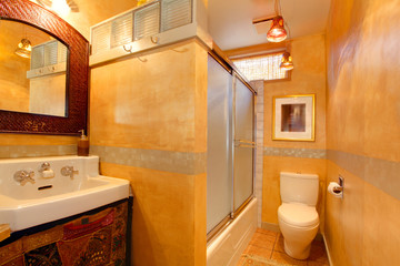 Exotic orange artistic bathroom with antique sink