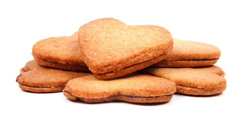 A pile of heart shaped biscuits filled with marmelade isolated o