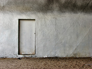 Metal door in the dirty wall