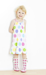 little girl wearing dress and rubber boots