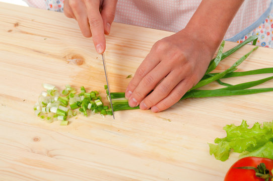 housewife preparing  spring onions