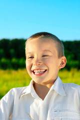 happy boy outdoor in the evening sunlight