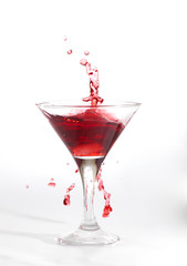 red martini cocktail splashing