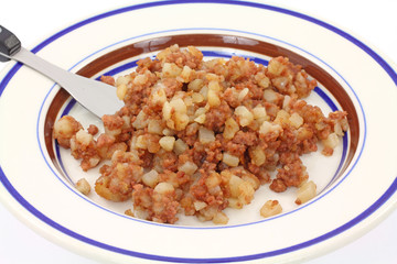 Corned beef hash on fork with plate underneath