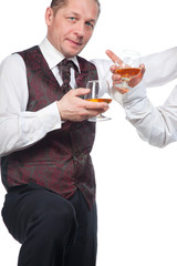 A man with a glass of brandy in his hand