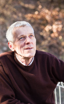 nice elderly white-haired man in a autumn park