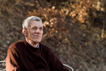 nice elderly white-haired man in a autumn park