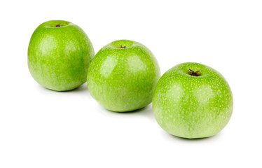 Three ripe and juicy green apples located in a line isolated