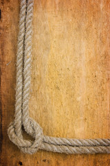 Fototapeta na wymiar frame made of rope on the old board
