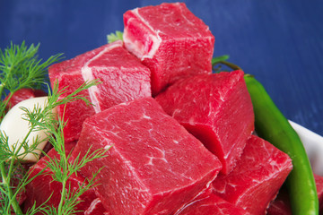 fresh uncooked beef meat slices over white bowls