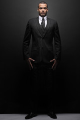 Young businessman in a black suit.