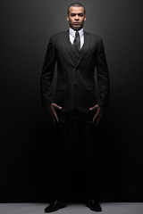 Obraz premium Young businessman in a black suit.