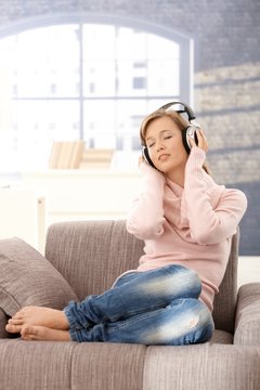 Young woman listening music at home