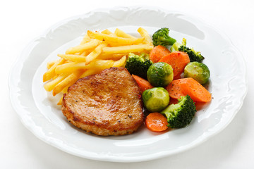 Pork chop, French fries and vegetables