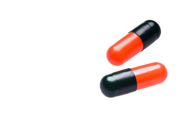 Two Bicolor capsules over white