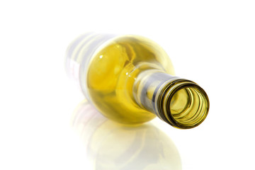 Empty wine bottle in closeup over white background