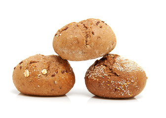 three fresh baked buns in closeup over white background
