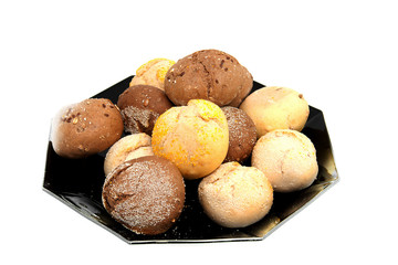 Black plate with fresh baked buns over white background