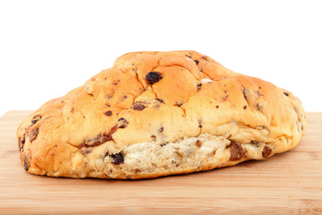 raisin bread on wooden cutting board over white background