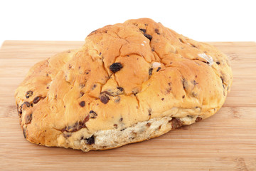 raisin bread on wooden cutting board over white background