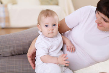 a young mother with her infant baby at home