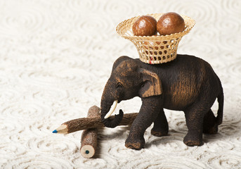 Wooden elephant carry nut in the basket