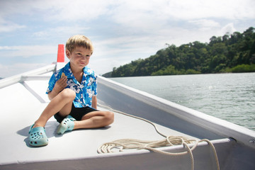 young boy traveling on boat