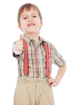 cheerful little boy showing thumbs up