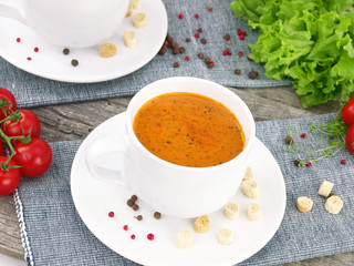 Tomato soup with fresh ingredients in a soup cup