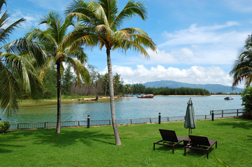 Sunbeds at lawn of luxury villa, Phuket, Thailand