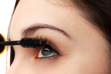 Woman applying mascara