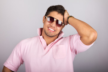 Fototapeta premium Young fashion man model with athletic body posing in sun glasses